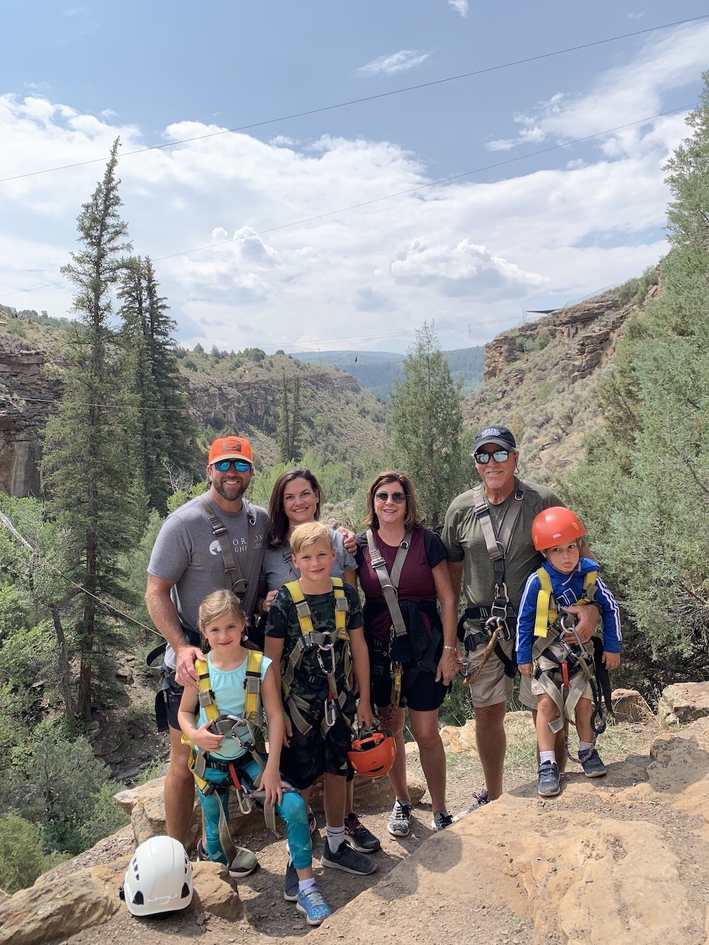 Adam and his family posing on a mountain