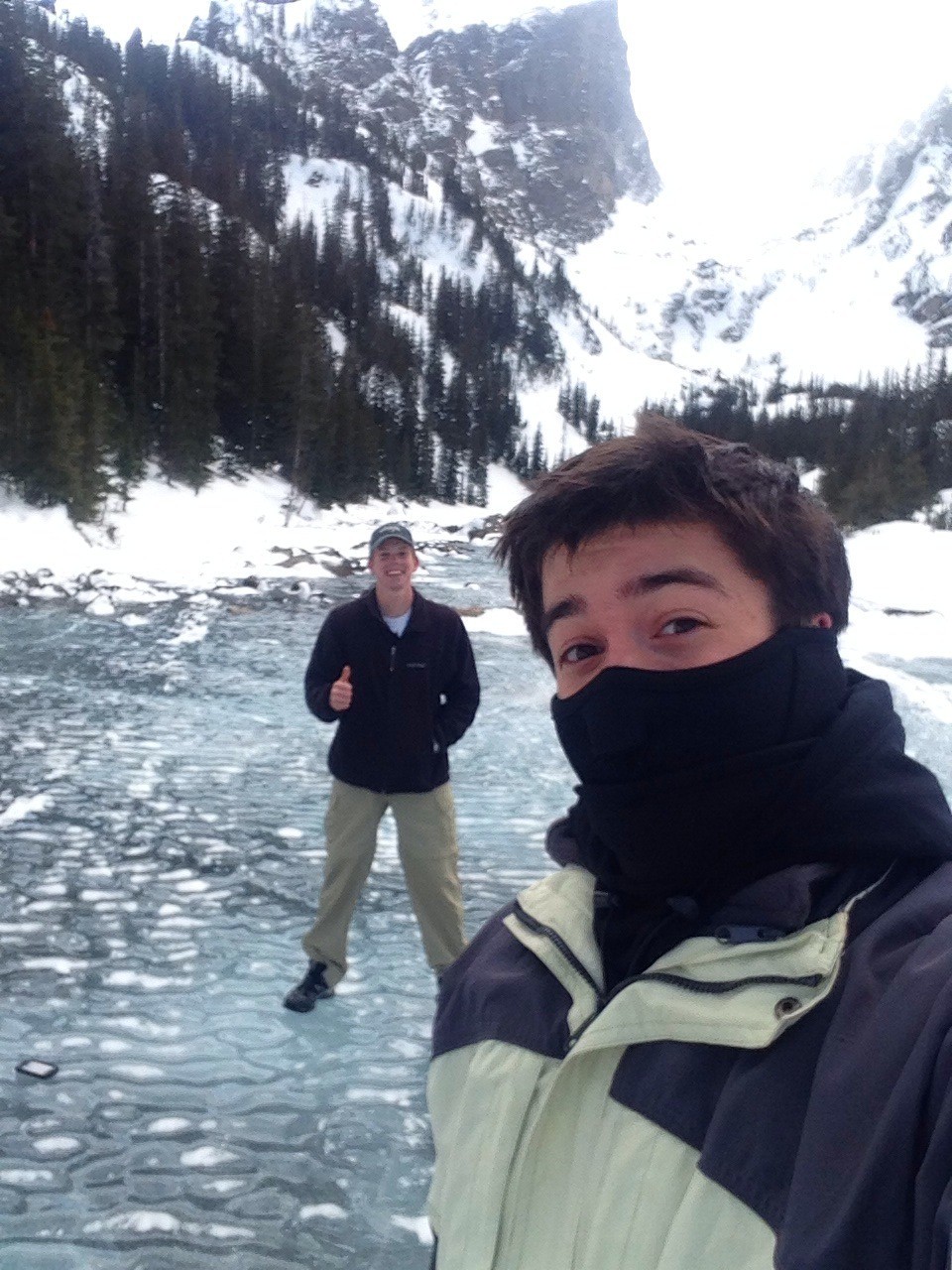 Aidan and his friend taking a selfie in the mountains