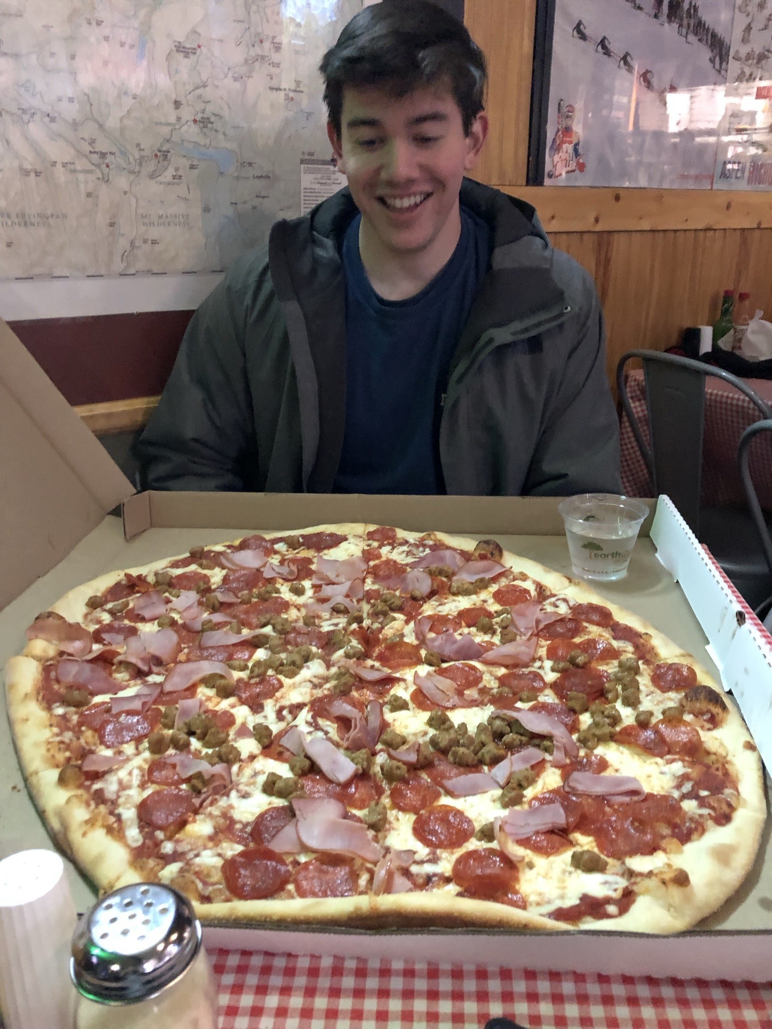 Candid Aidan with a large pizza