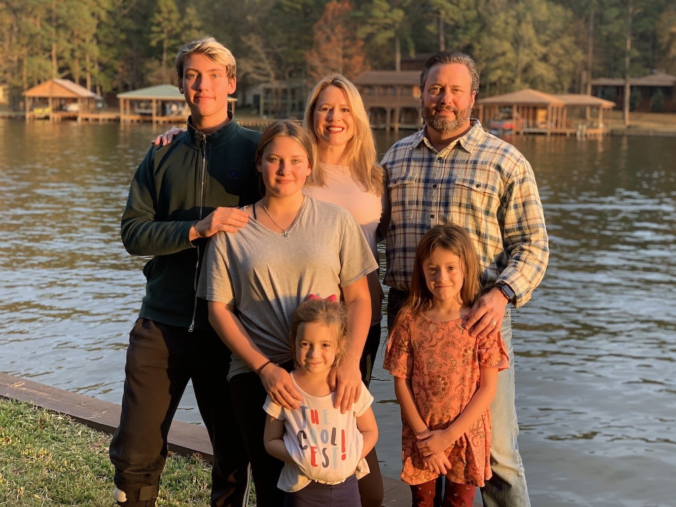 Jason and his family in front of a lake