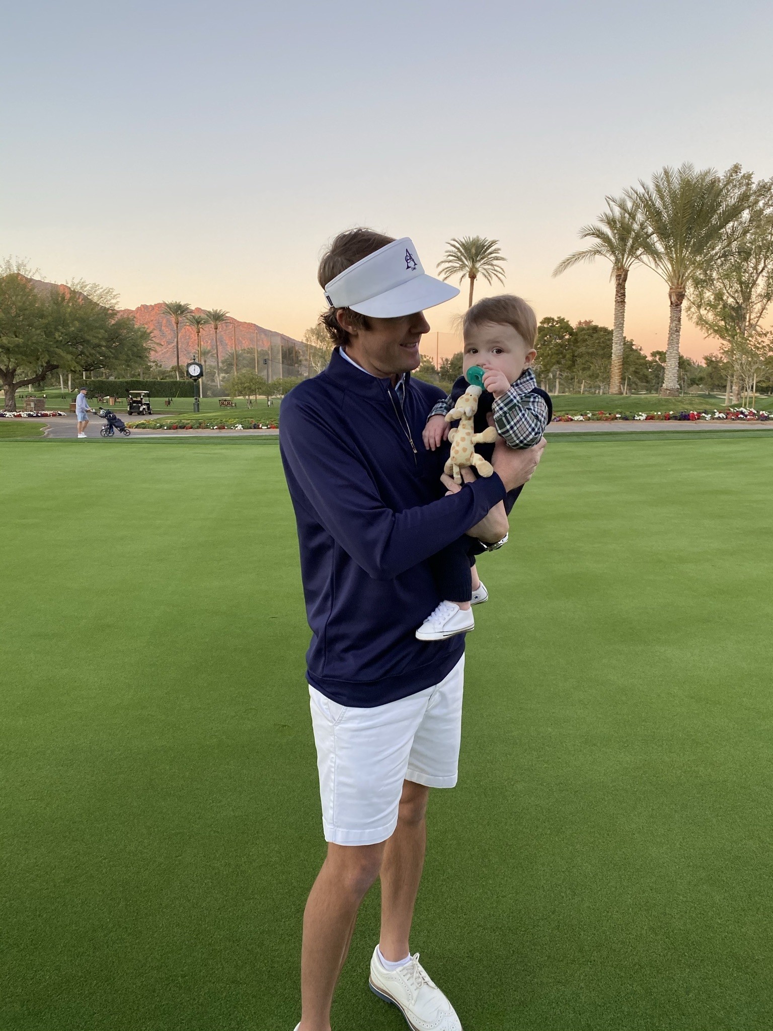 Mike with his son on a golf course
